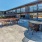 a patio with tables and chairs outside